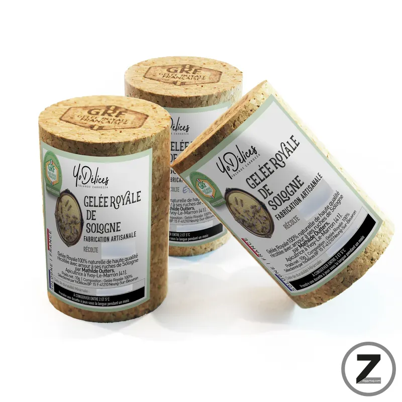 Three cork-wrapped cheese wheels with labels reading 'Gelee Royale de Soigne', showcasing artisanal production on a white background.