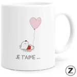 White mug with a small cartoon dog holding a pink heart-shaped balloon and the caption 'JE T'AIME …'