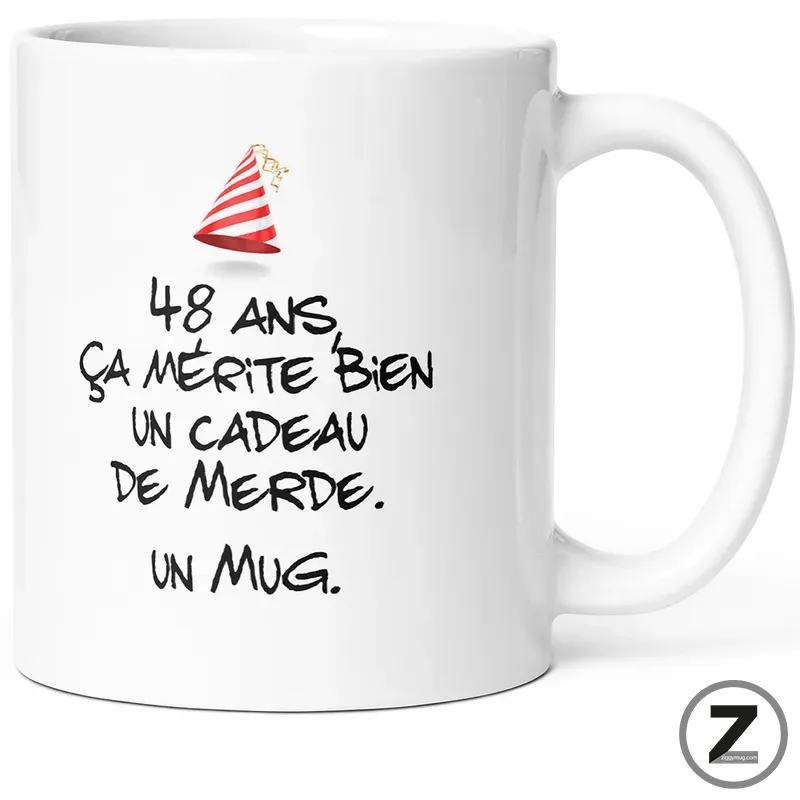 White mug with handwritten French text joking about turning 48 and getting a crappy gift, with a small party hat graphic.