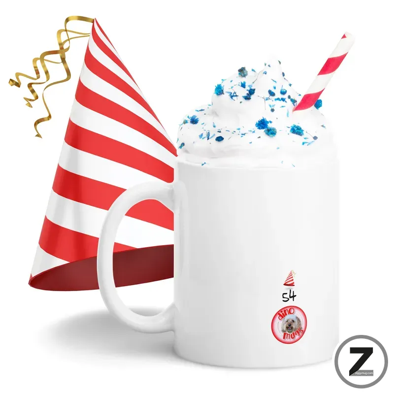 White mug topped with whipped cream and blue sprinkles, with a red-and-white striped party hat and striped straw for a festive celebration symbolically attached to the mug.