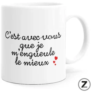 White ceramic mug featuring black cursive French text and small red heart icons on a plain white background.