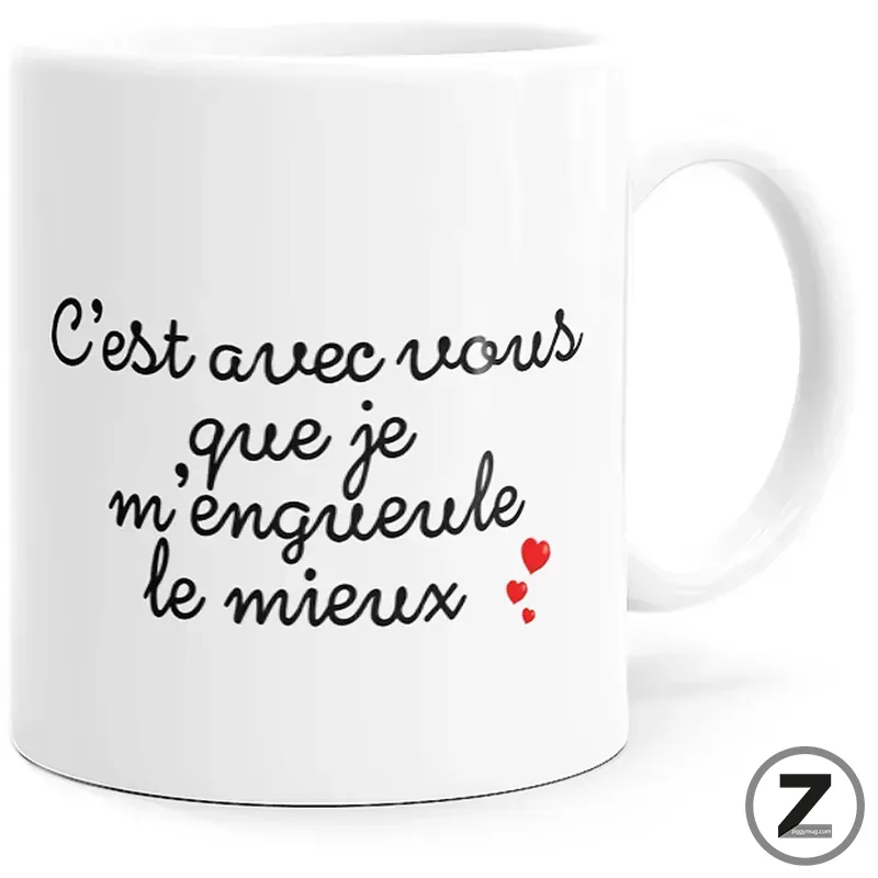 White ceramic mug featuring black cursive French text and small red heart icons on a plain white background.