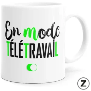 White mug printed with the phrase 'En mode télétravail' in black and green letters plus a small green toggle icon.