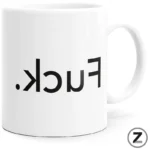 White ceramic mug with black text reading 'fuck' shown upside down from the side?