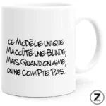 White mug with black handwritten French quote.