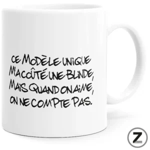 White mug with black handwritten French quote.