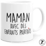 White ceramic mug featuring black handwritten French text 'Maman avec des enfants parfaits' and a small red heart.
