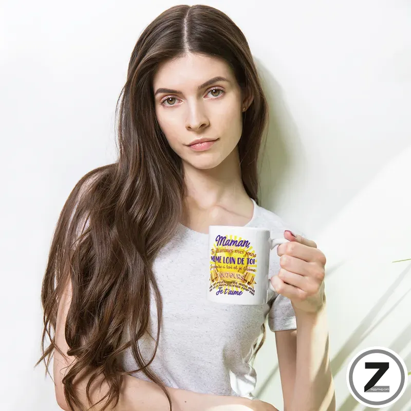Young woman with long brown hair holding a white mug with colorful French text against a white background.
