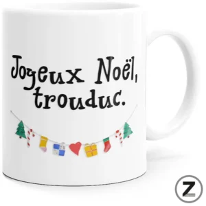 White ceramic mug with the French holiday message 'Joyeux Noel, trouduc.' in black, and a string of colorful festive decorations beneath.