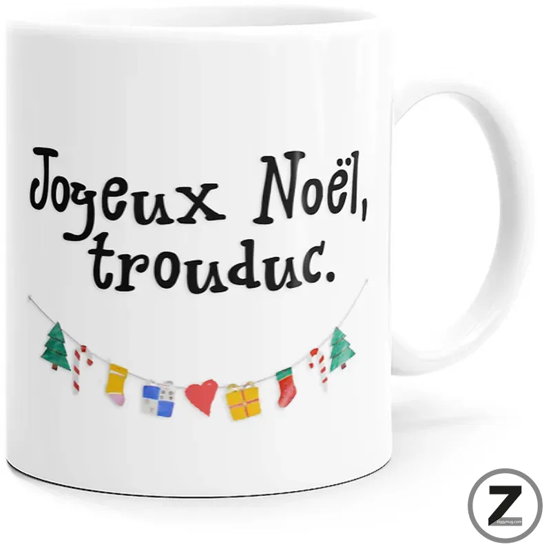White ceramic mug with the French holiday message 'Joyeux Noel, trouduc.' in black, and a string of colorful festive decorations beneath.