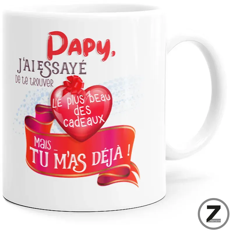 White mug featuring a pink heart and red ribbon with French text: 'Papy, j'ai essayé de te trouver le plus beau des cadeaux mais tu m'as déjà!'