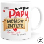 White ceramic mug with colorful French text celebrating grandpa: 'Le meilleur Papy du monde entier' with red hearts and decorative banner