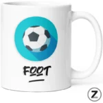 White mug with a teal circular logo showing a soccer ball inside and the word FOOT in bold brush lettering underneath.