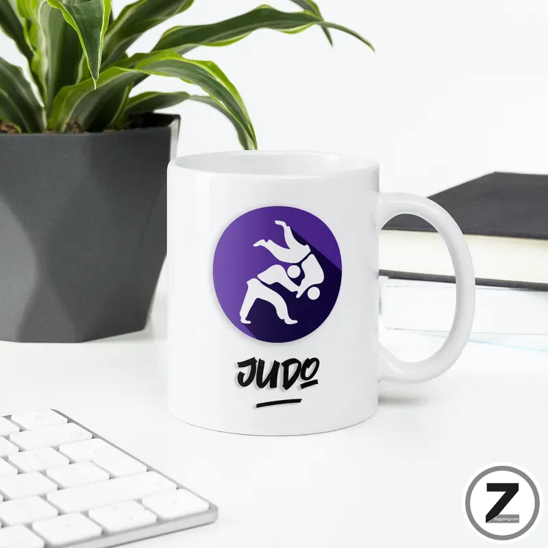 White mug with a purple circular Judo logo showing two white-clad practitioners in a throw, and the word JUDO beneath.