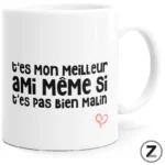 White ceramic mug displaying a humorous French phrase in black text with a small pink heart drawing nearby: 't'es mon meilleur ami même si t'es pas bien malin'