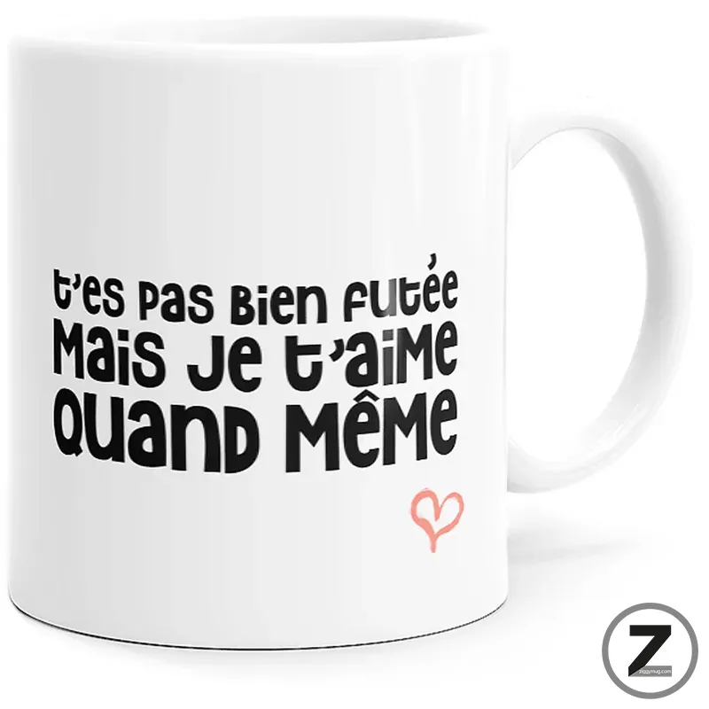 White mug with bold black French phrase 't'es pas bien foutée mais je t'aime quand même' and a small pink heart.