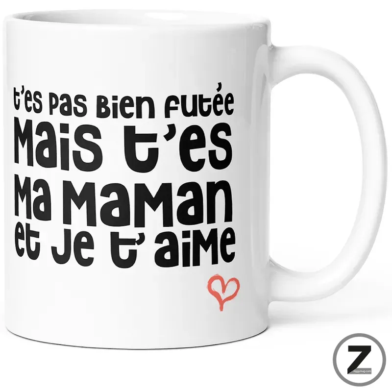 White ceramic mug featuring a bold black French phrase: t’es pas bien foutée mais t’es ma maman et je t’aime, with a small red heart.