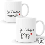 Two white mugs with handwritten French phrases 'je t'aime maman' and a small red heart; and 'je t'aime papa' on the other mug, set against a white background.